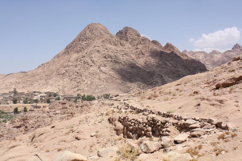 Figure 5 The Byzantine water conduit of Wadi Arba’ien (Leja) and contemporary water pipeline supplying Saint Catherine Monastery at average elevation of 1,600 m ASL (in the background are the pyramid-shaped Gebel Rubsha (El Ghabsheh) at 1,858 m ASL, and t Figure 5 The Byzantine water conduit of Wadi Arba’ien (Leja) and contemporary water pipeline supplying Saint Catherine Monastery at average elevation of 1,600 m ASL (in the background are the pyramid-shaped Gebel Rubsha (El Ghabsheh) at 1,858 m ASL, and t